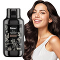 Black hair dye bottle with floral design next to a woman with long, wavy hair.